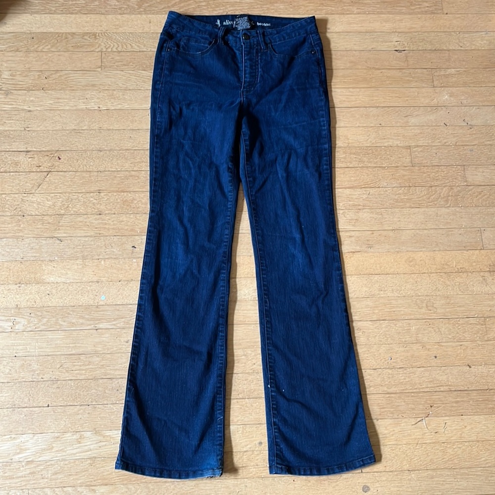 Bootcut dark wash blue jeans with a high waist, and five usable pockets.